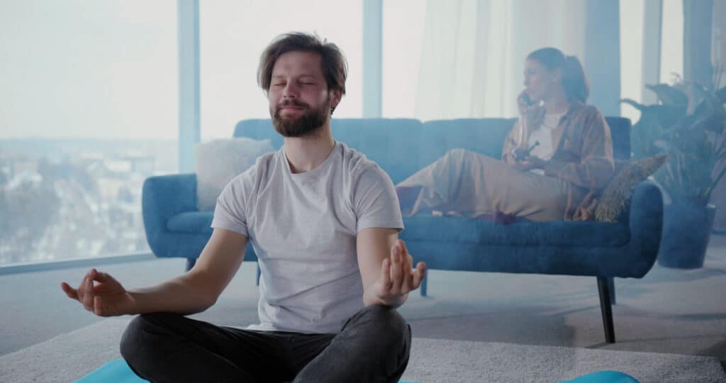 Man practicing ganja yoga from home